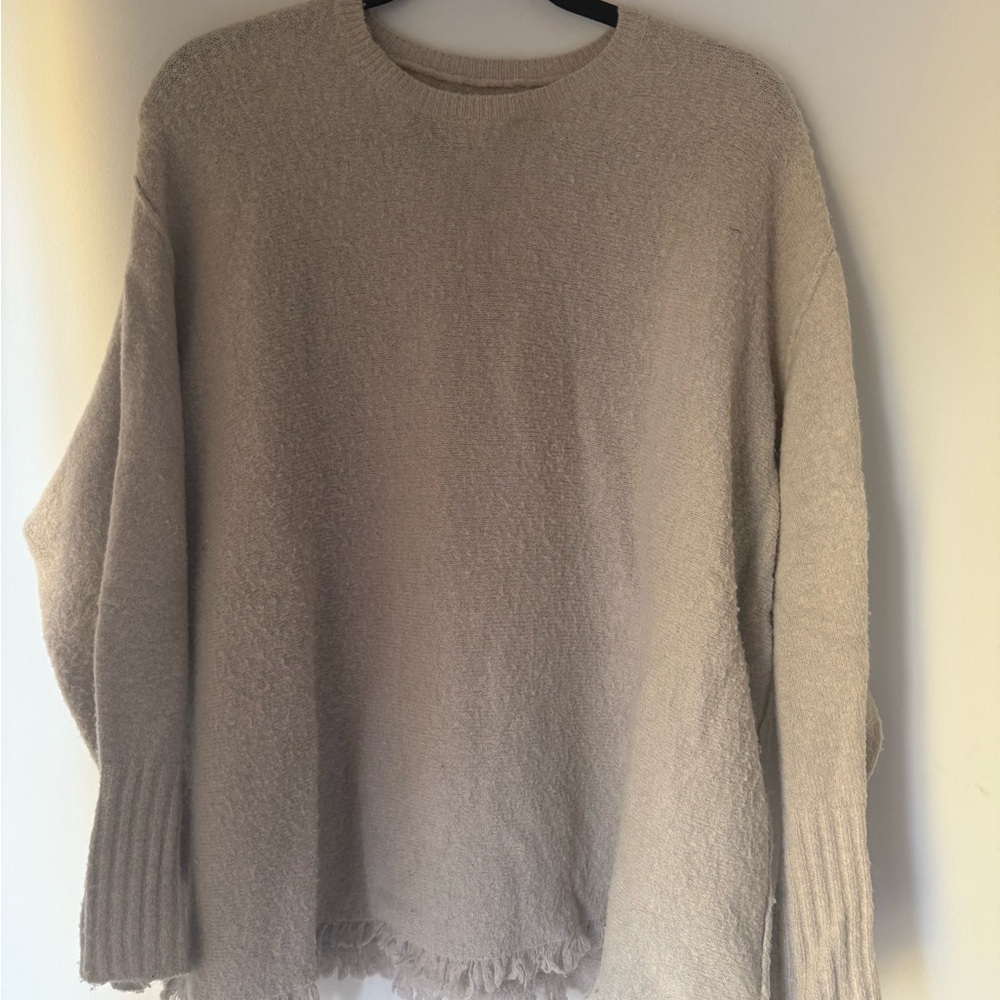Cozy Beige Women's Sweater with distressed detail at bottom